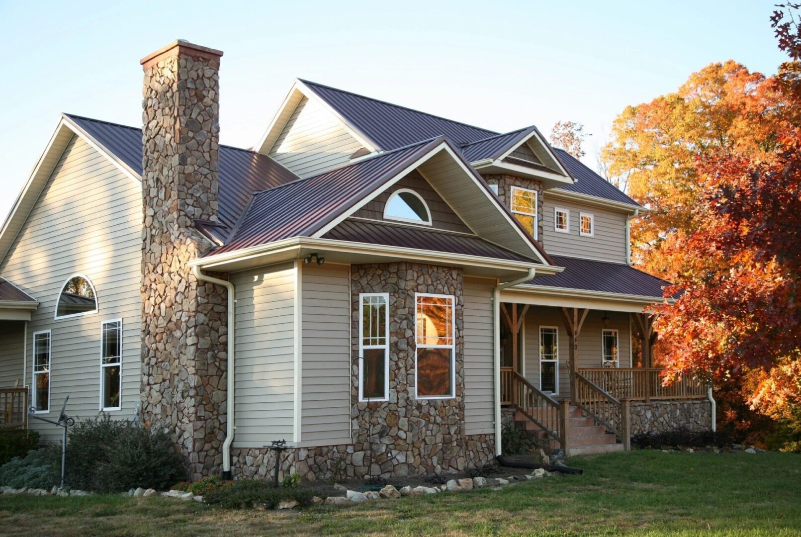 Real estate agents selling two-story home with stone veneer in Riverside, CA.